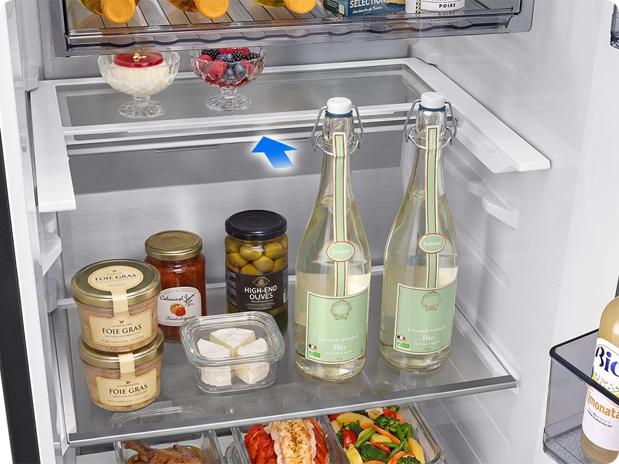 An arrow indicates that the fridge shelf slides in halfway, allowing you to store not only low food containers but also tall bottles on the shelf.
