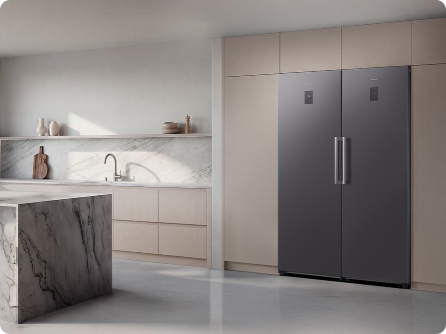 The fridge and freezer are installed in the modern kitchen. The sleek exterior of the refrigerator gives a clean look to the modern kitchen, with a flat finish.
