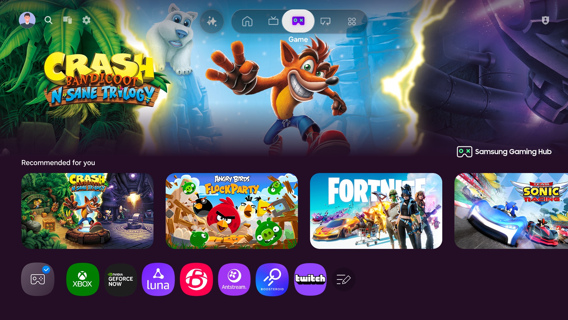 A TV displays the Samsung Gaming Hub home screen, which has options for streaming and playing games.