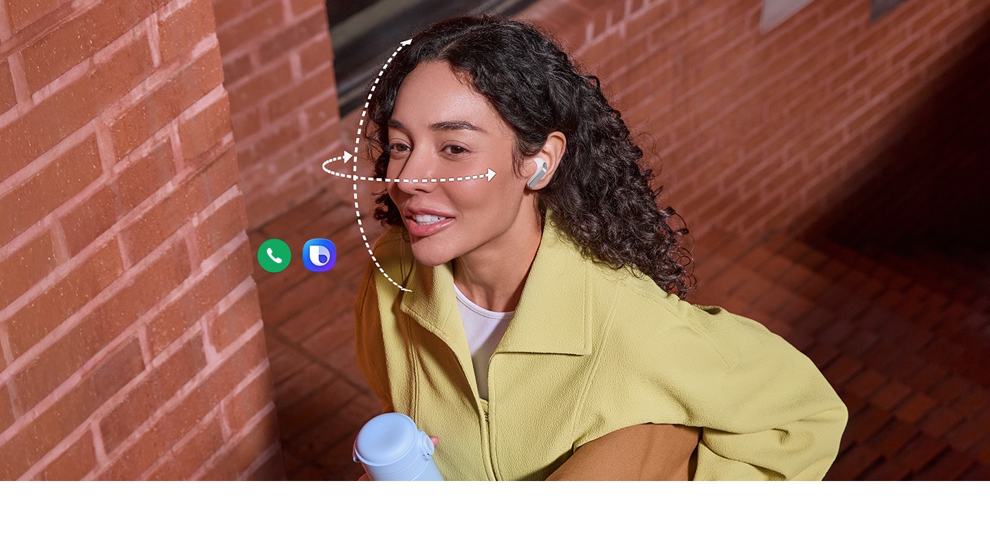A person wearing Galaxy Buds4 in White, while holding a tumbler in one hand and a bag in the other. Dotted vertical and horizontal lines wrap around her face to show the Head Gesture function available on the Galaxy Buds4. Call app icon and Bixby icon indicates the two features can be used for Head Gesture.