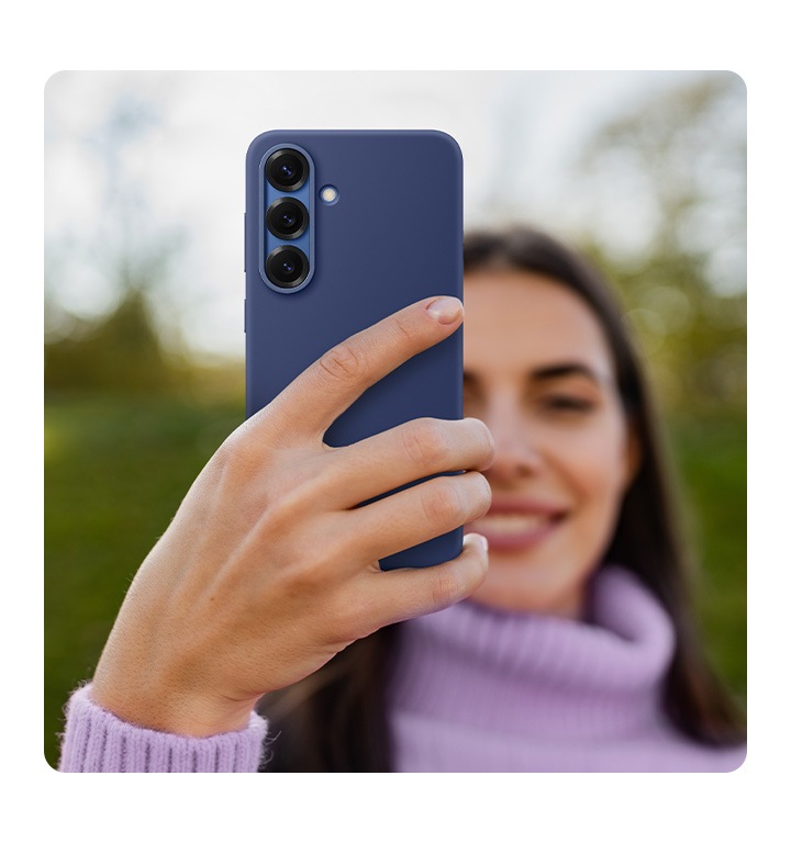 A person holds a Galaxy S25 installed with the Silicone Case in Blue.