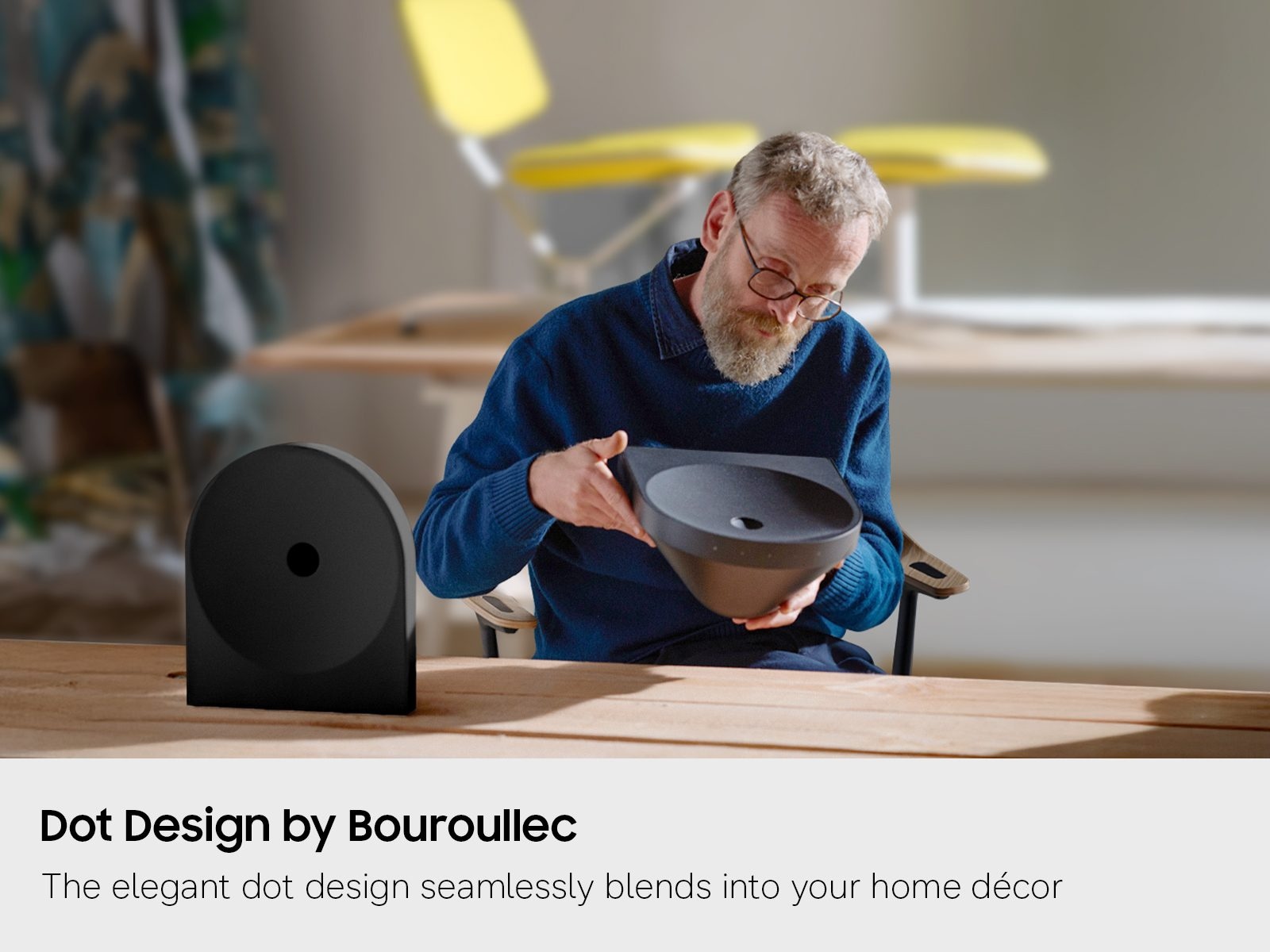 A lifestyle shot of French artist Erwan Bouroullec inspecting the design of the Music Studio LS50H.