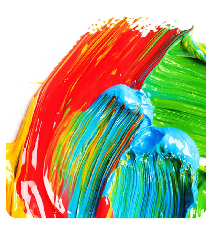 Red, green, blue and hints of yellow paint is smeared on a white background. The colors slightly mix, showing more details of complex colors that form on the paint.