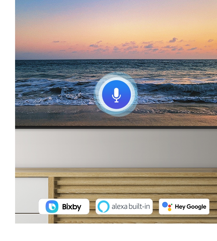 A microphone icon overlays a beach sunset TV screen image, demonstrating UHD TV voice assistant feature.