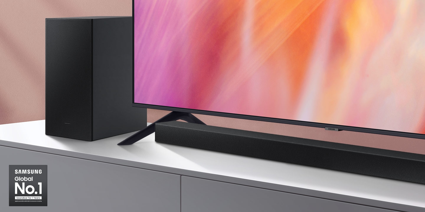 Samsung Global No.1 logo can be seen along with Samsung A series Soundbar and subwoofer which are positioned next to Crystal UHD TV.