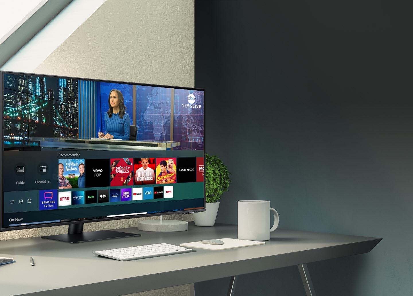 The Samsung TV Plus app is running on the monitor on the desk.