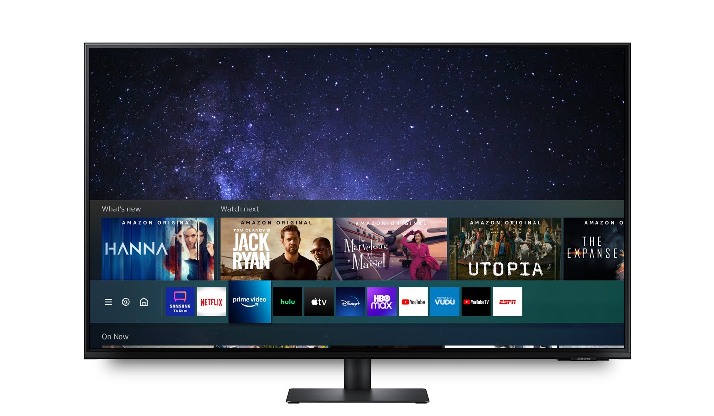 The Smart TV Apps screen is displayed on the monitor, and the Prime Video icon is selected. The screen freezes while The Marvelous Mrs. Maisel of Prime Video is playing. Part of the screen is enlarged, comparing Full HD (1920×1080) and UHD (3840×2160). The UHD (3840×2160) screen looks clearer.