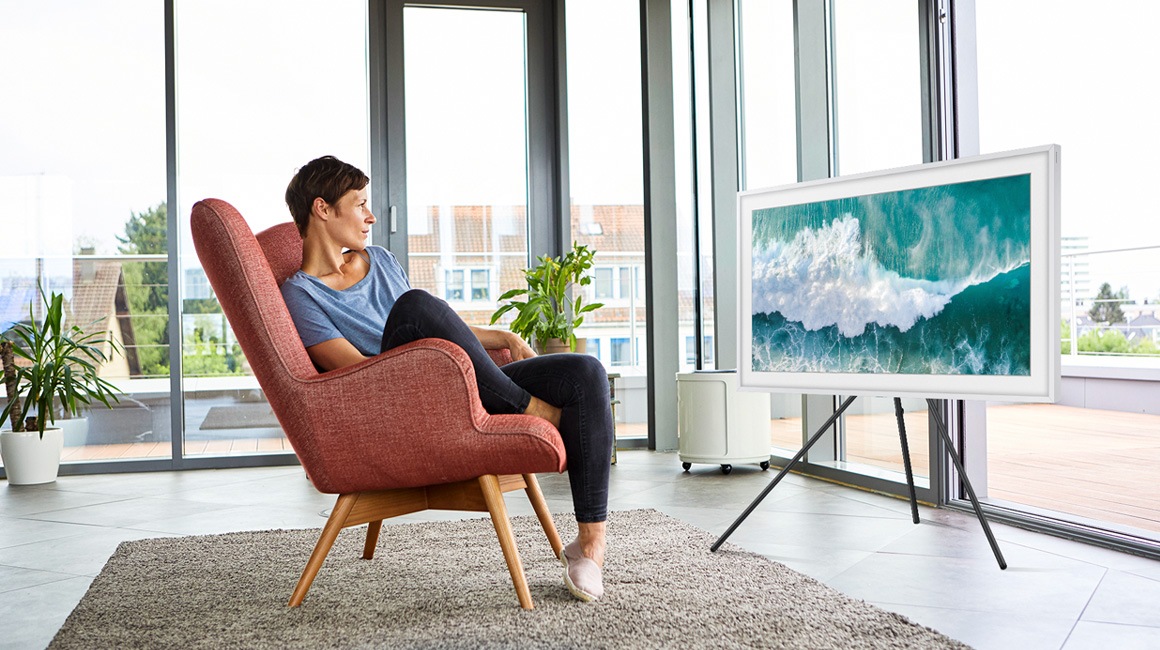 TV on Stand next to sofa.