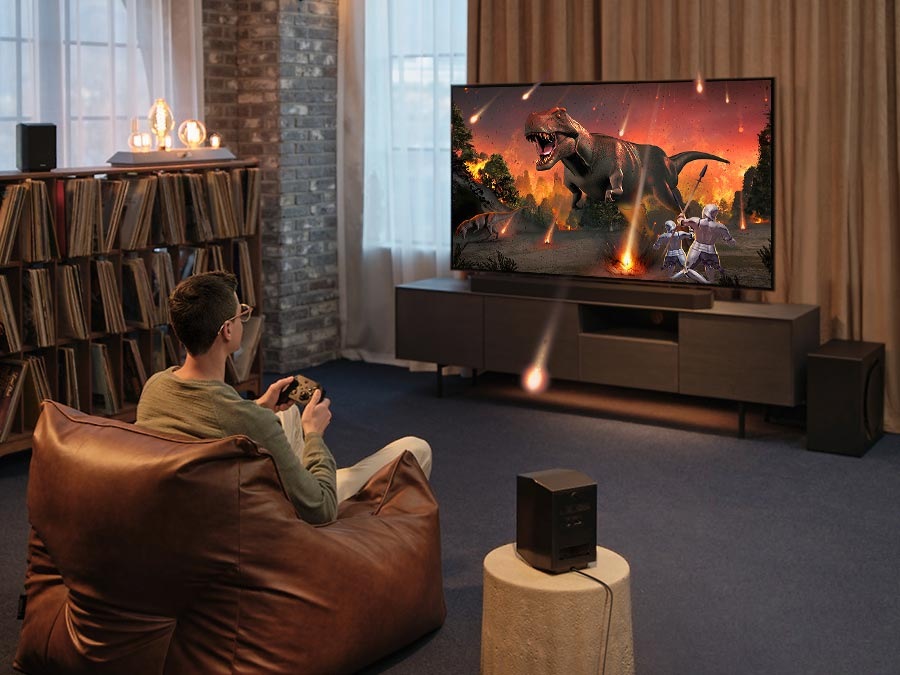 A man enjoys an immersive 3D-like gaming experience with Samsung Soundbar Game Mode Pro.