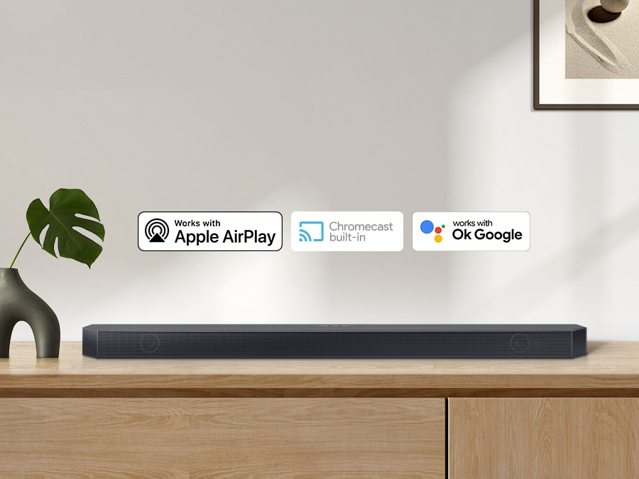 Chromecast built-in logo and Works with OK Google and Apple AirPlay logos with a Samsung Q series Soundbar.