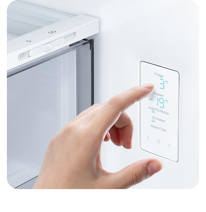 A hand touches the LED screen inside the fridge, with water and ice controls, and temp settings for the fridge and freezer.