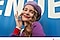 Một người phụ nữ đang mỉm cười và mặc trang phục màu tím, chụp ảnh selfie chất lượng cao trước phông nền màu xanh lam. Biểu tượng camera và dòng chữ #WithGalaxy được hiển thị.