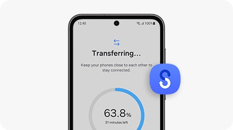 A Galaxy S23 FE device shows the progress bar of a Smart Switch data transfer onscreen.