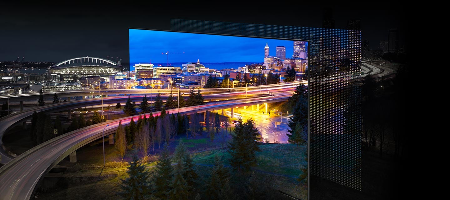 Một thành phố được thắp sáng bởi ánh đèn rực rỡ đang được trưng bày. Màu sắc và ánh sáng sống động khi đèn OLED hiển thị qua màn hình QD.
