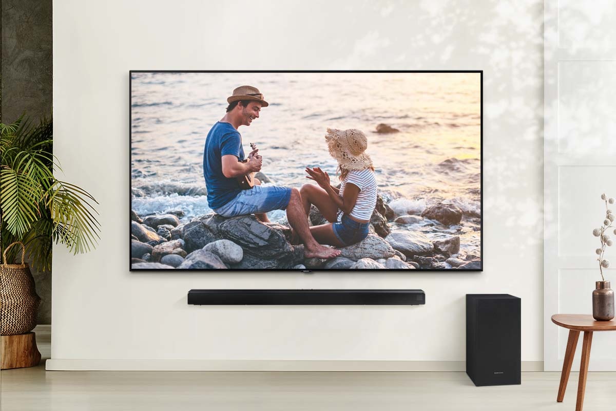 Loa thanh Samsung A650, loa siêu trầm và TV trong phòng khách.
