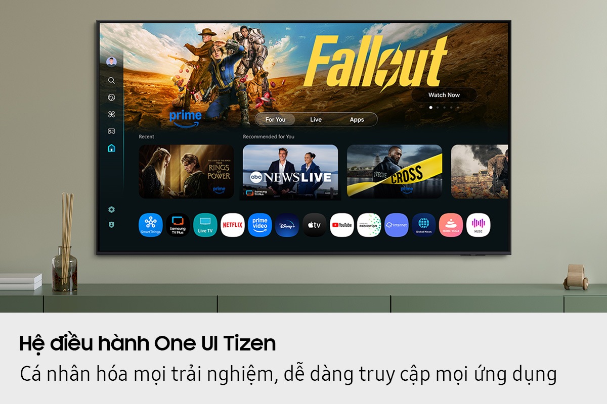 One UI Tizen’s home screen, with the various apps and services available, is displayed on a TV in a living room.
