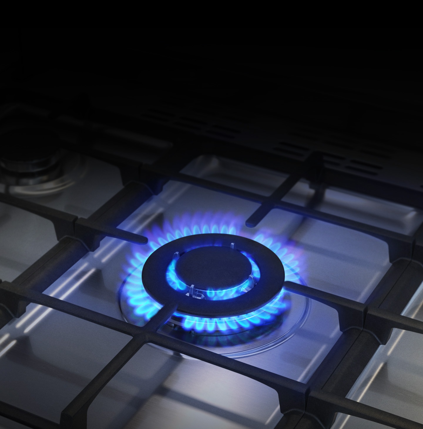 A close-up of the Triple Power Burner shows its three concentric rings of flame.