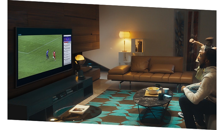 A group of people use QLED TV Multi view feature to enjoy a football match and view play-by-play information at the same time on the same screen.