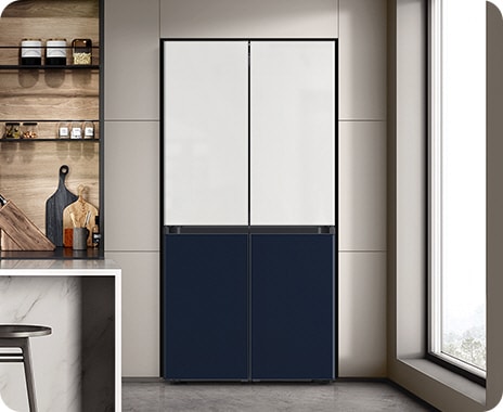 Placed in a stylish kitchen, the refrigerator has a two-tone finish that blends seamlessly with the tones of the room.
