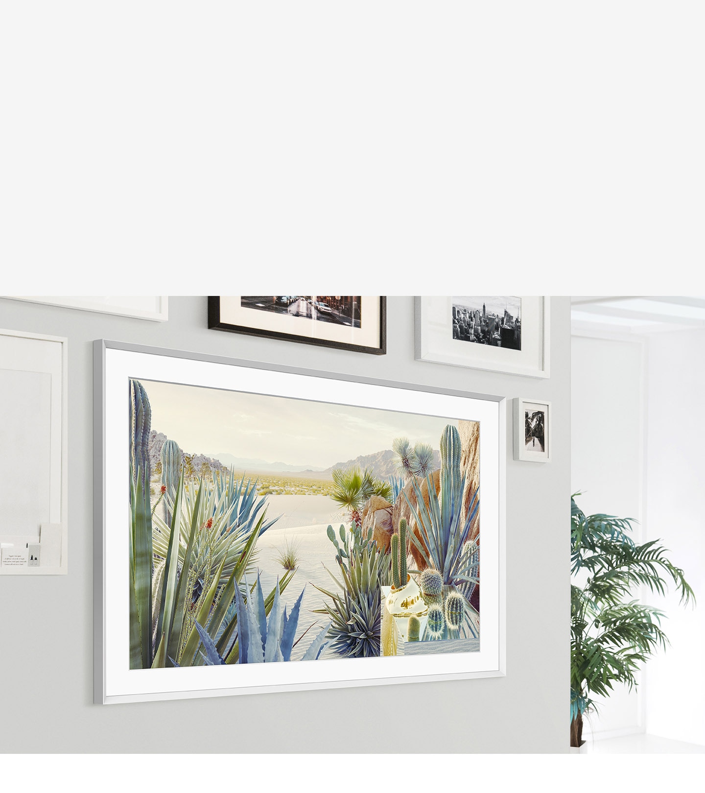 The Frame is mounted on the wall of a home interior and its modern frame design blends with the other picture frameson the wall.