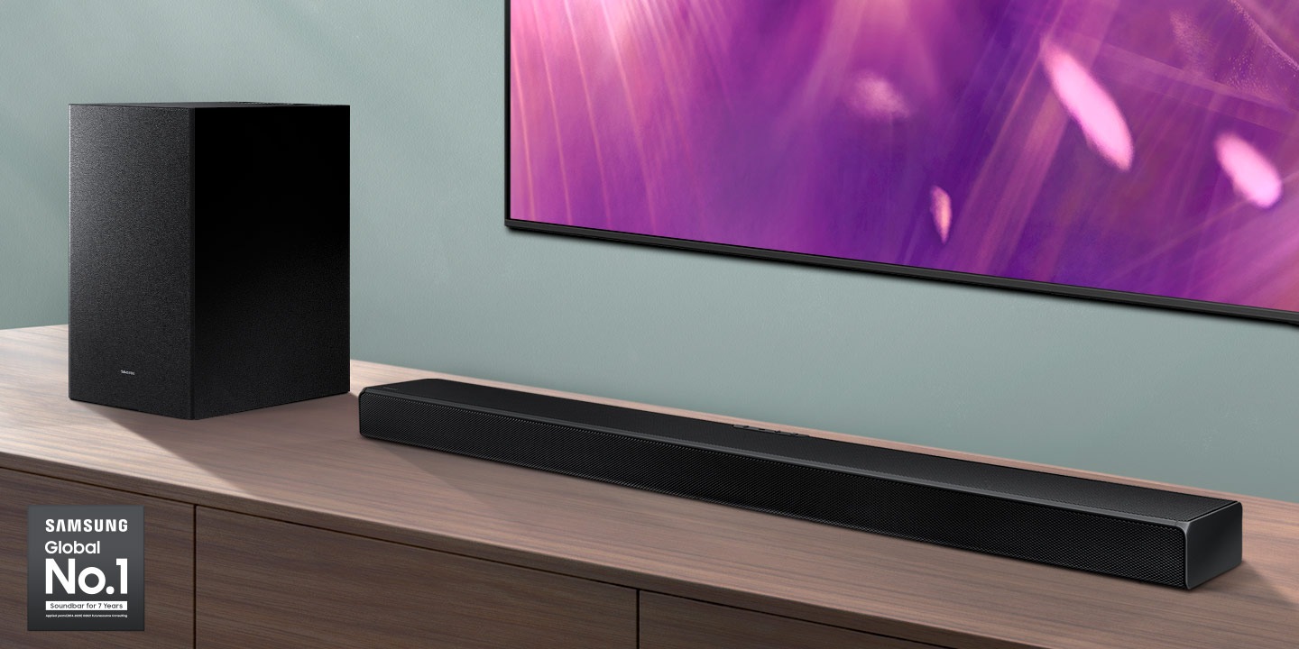 Samsung Global No.1 logo can be seen along with Samsung A650 Soundbar and subwoofer which are positioned next to Crystal UHD TV.