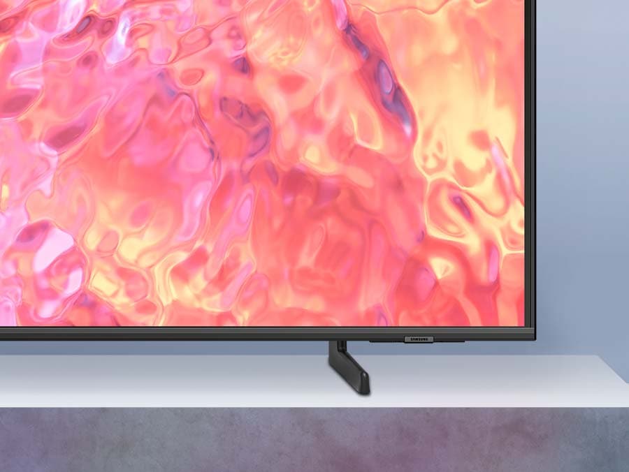 A QLED TV is placed on an Adjustable Stand.