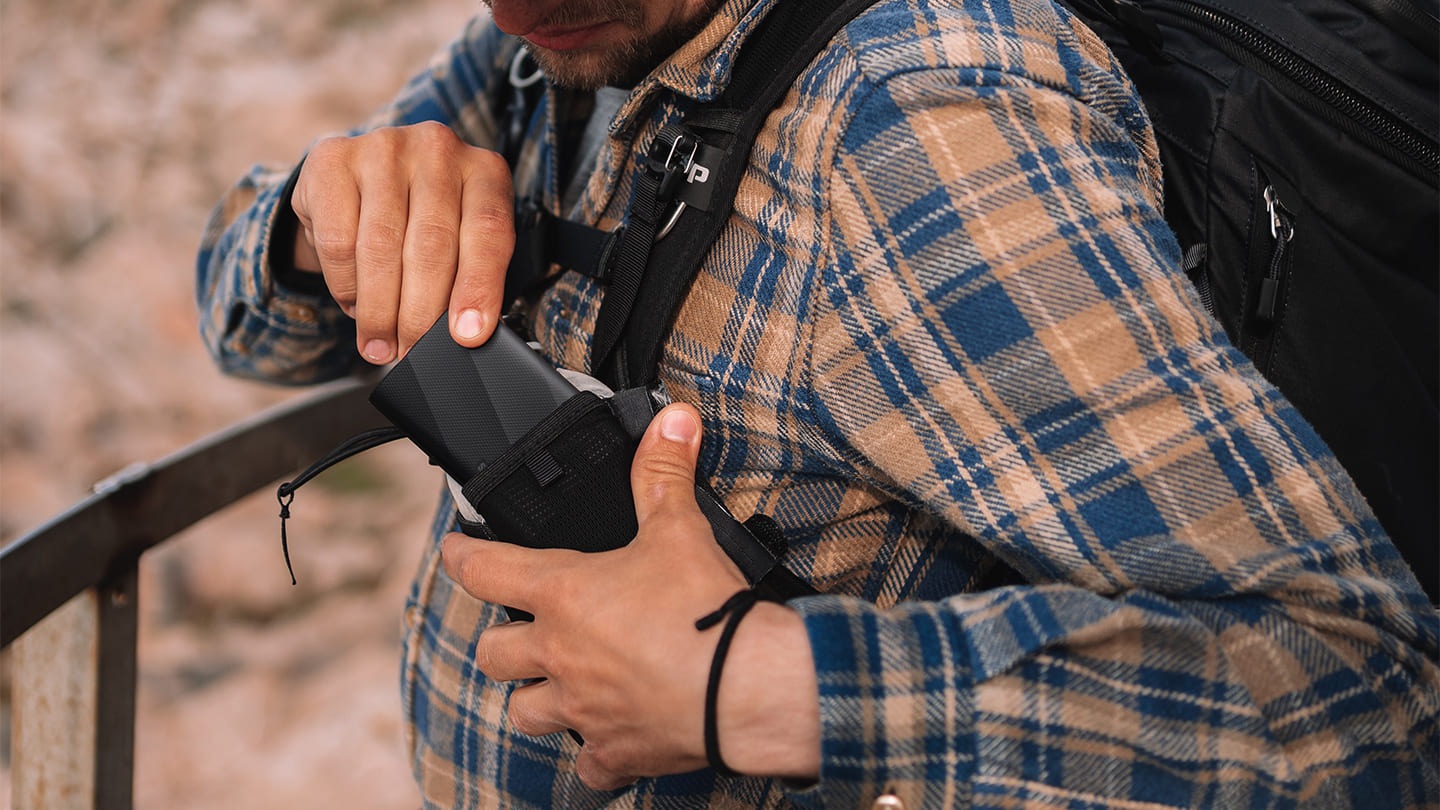 A person is taking out his T9 device from his bag pocket.