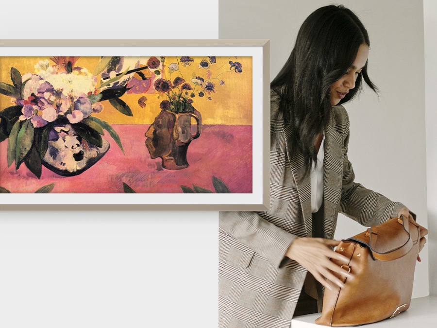 A woman packs her bag and leaves. The Frame, which was displaying an artwork, turns off once it sensed there was no one in the room.