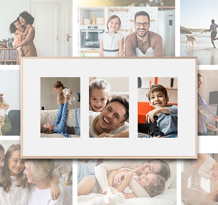 The Frame TV hangs on a wall, displaying three different family pictures on a white matte background.