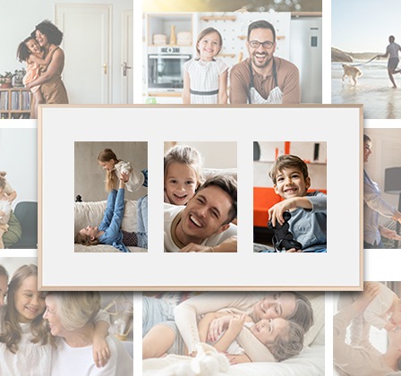 The Frame TV hangs on a wall, displaying three different family pictures on a white matte background.