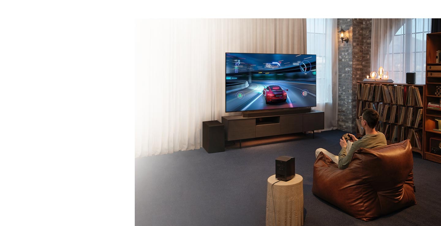 A man enjoys an immersive 3D-like gaming experience with Samsung Soundbar Game Mode Pro.