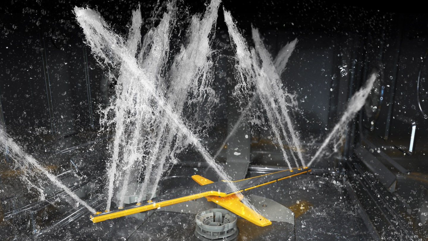 Shows the rotating dual wash arms of the WaterJet Clean™ system spraying powerful jets of water in multiple directions.