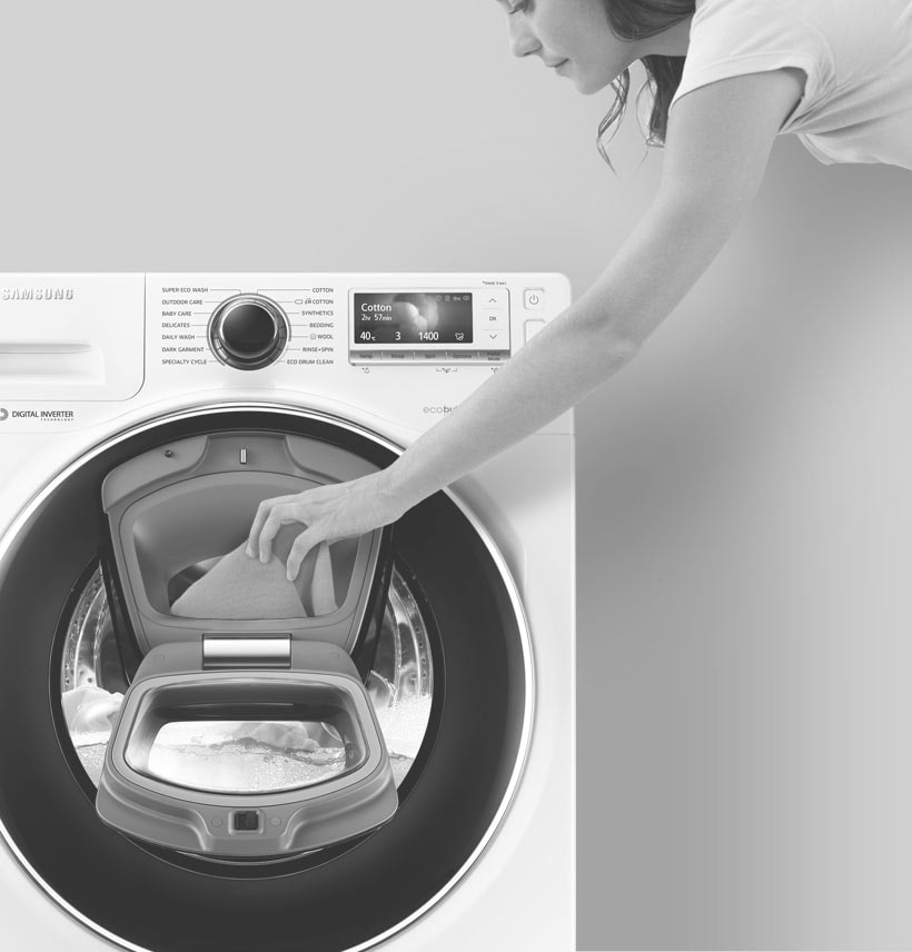 An image showing a woman adding an item to the wash via the Add Door. 