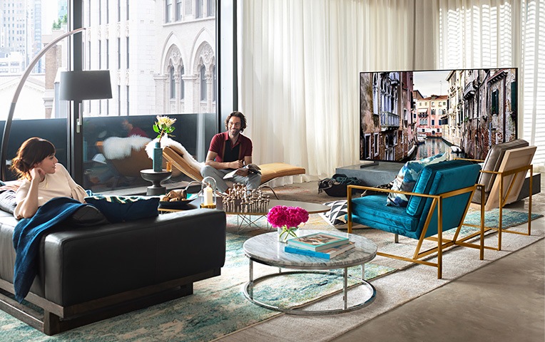 a woman facing front, TV back