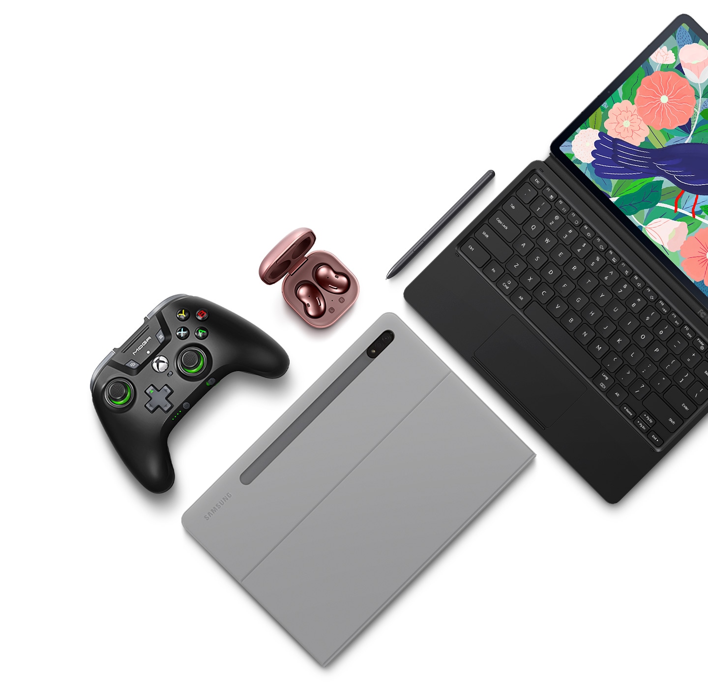 Flat lay of Galaxy Tab S7+ and its accessories. A Galaxy Tab S7+ attached to the BookCover Keyboard, a Galaxy Tab S7+ inside the BookCover, S Pen, game controller, and Galaxy Buds Live