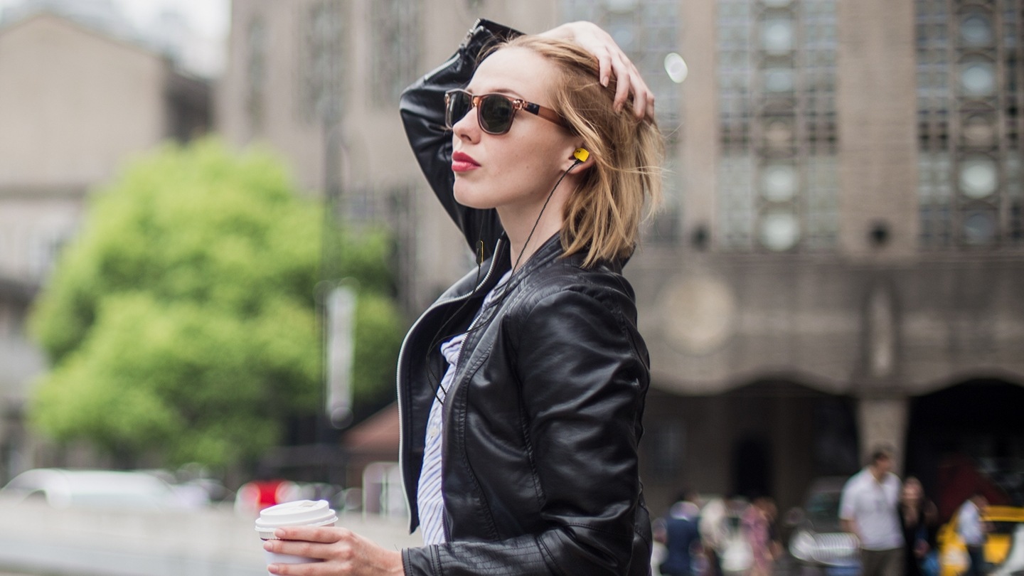 한 여자가 옐로우 색상의 제품을 착용하고 있는 옆모습이 보입니다. 