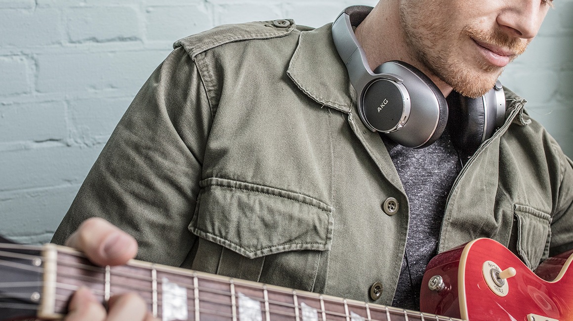 [사용자가 ÁKG Ñ~700ÑCM2를 착용하고 기타를 연주하고 있는 이미지를 볼 수 있습니다.]