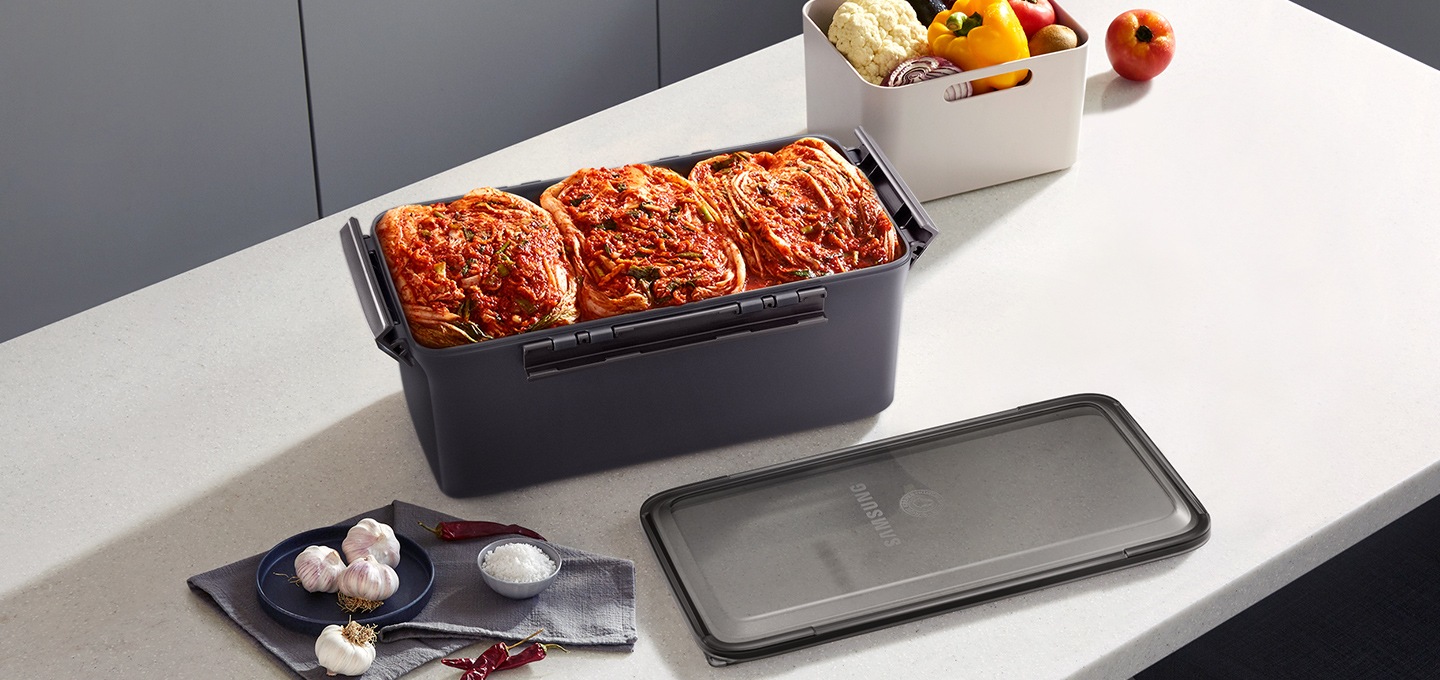 식탁에 토프 김치통에 담긴 김치가 보이고 있습니다.