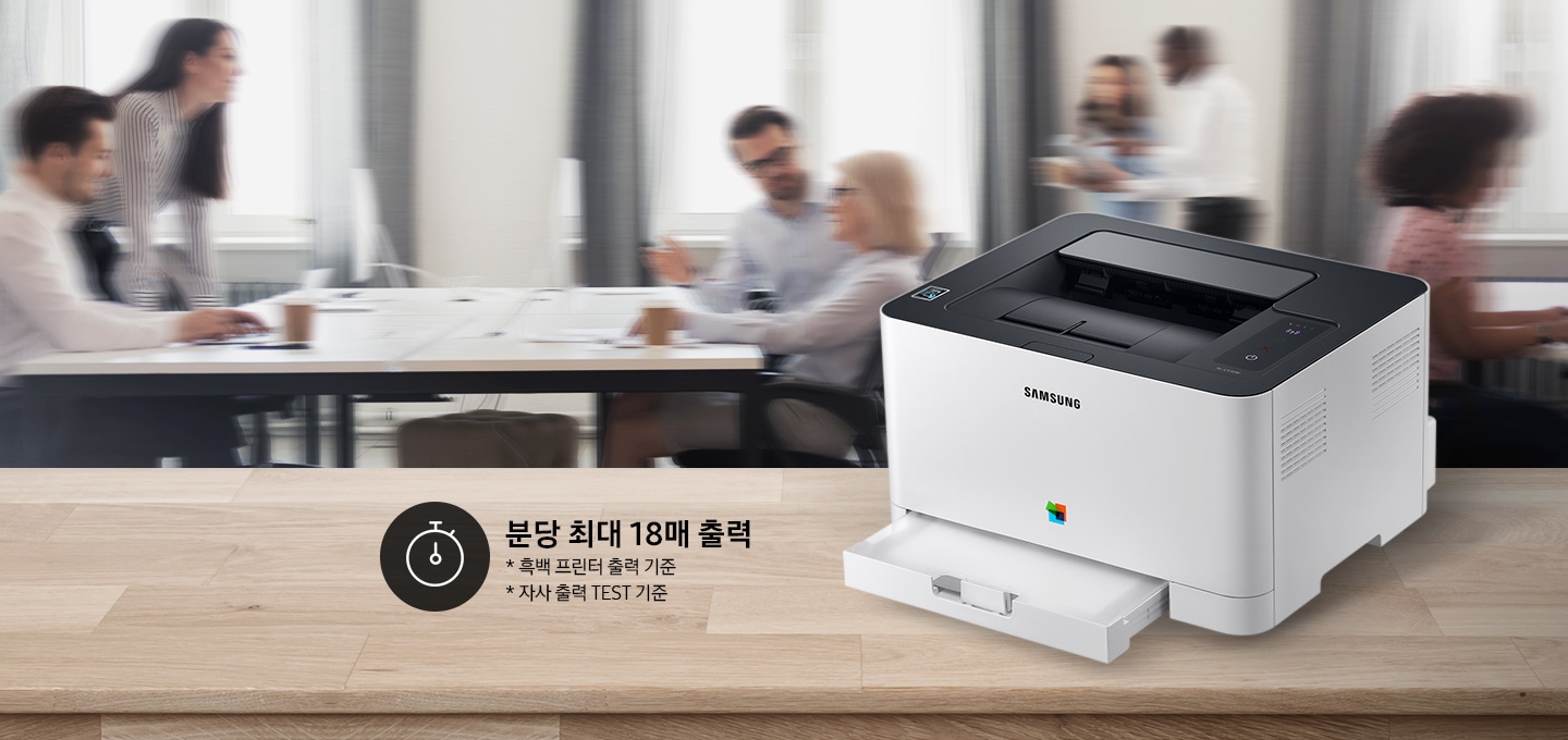배경에는 바쁘게 회의를 하는 사람들의 모습, 바쁘게 지나가는 사람들의 모습이 흐릿하게 나와 있으며 이미지 오른쪽 부분에는 제품 오른쪽 위에서 내려본 이미지가 배치하여 있고이미지 왼쪽 하단에 분당 최대 18매 출력, * 흑백 프린터 출력 기준, 자사 출력 TEST 기준 텍스트가 쓰여 있으며, 타이머 아이콘이 나와있습니다.