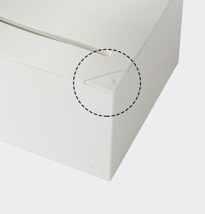 라벨프린터 디스펜서 버튼 부분이 확대되어 보이고 있습니다.