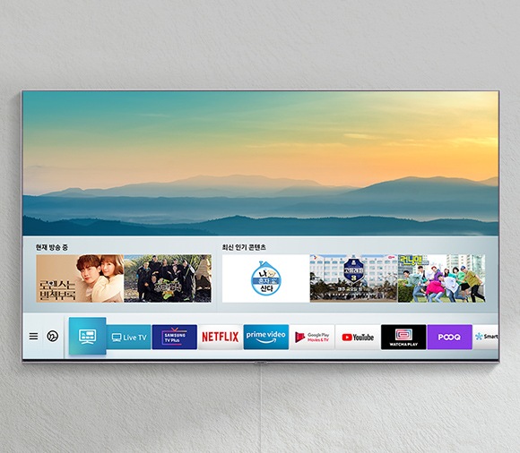 TV가 벽에 걸려있고 인스크린 화면에 여러 콘텐츠들이 나오고 있습니다.