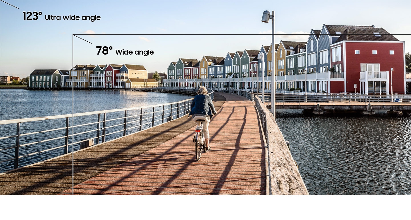 More ways to keep unforgettable moments. Comparison of a30 123 degree ultra wide view and 78 degree wide angle of a woman riding bicycle pier.