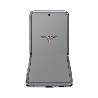 A front-table-top view of Samsung Galaxy Z Flip Thom Browne Singapore in Grey SM-F700FZAZXSP) shows a Thom Browne logo