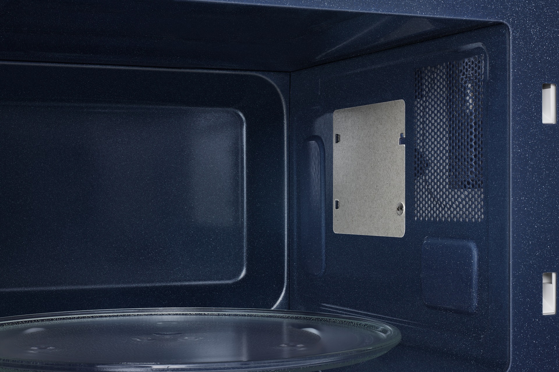 Close up of the interior of the Samsung Microwave Oven Solo with Home Dessert function 30L in black.