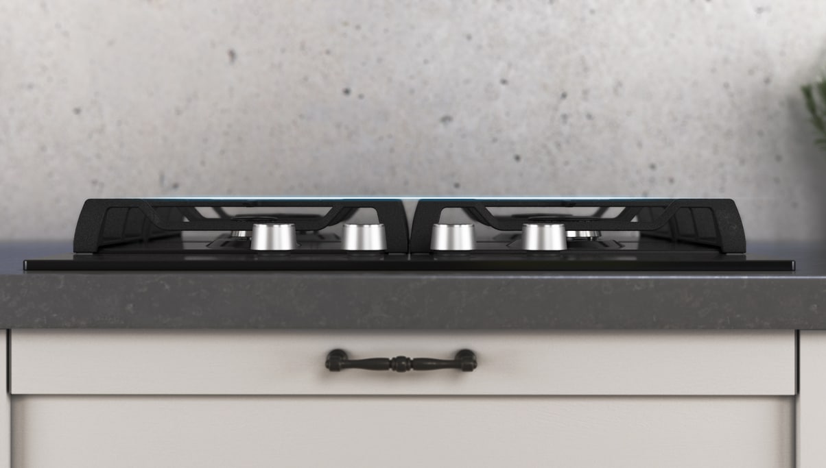 Vista lateral del anafe de vidrio negro empotrado en la mesada