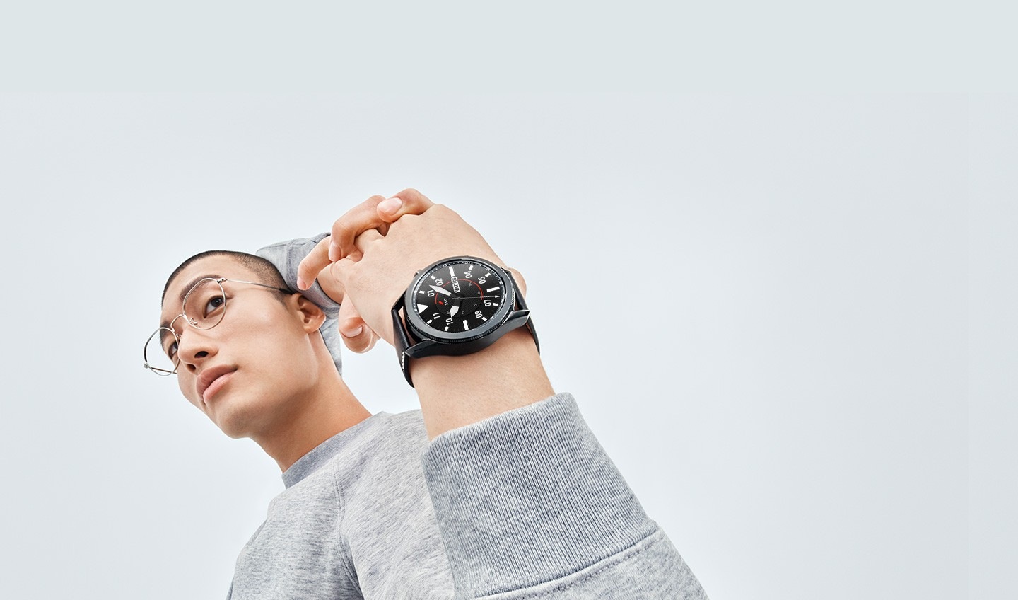 Man stretches his arms behind his back, showing off a 45mm Galaxy Watch3 in Mystic Black on his wrist with a Sporty Classic Watch Face.