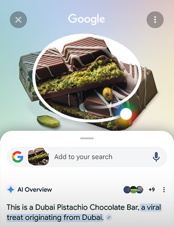 Viene tracciato un cerchio attorno a una tavoletta di cioccolato di Dubai. Sotto si vede la barra di ricerca di Google, con i risultati di Panoramica AI.