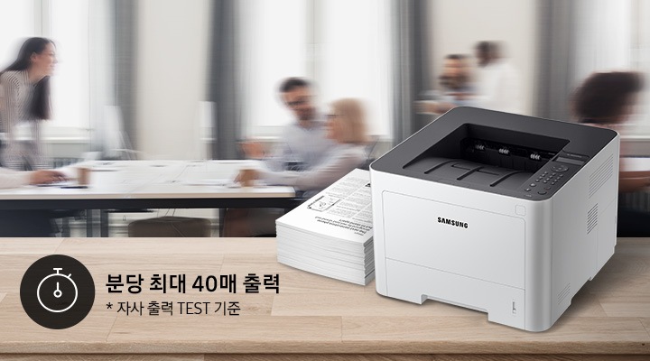 배경에는 바쁘게 회의를 하는 사람들의 모습, 바쁘게 지나가는 사람들의 모습이 흐릿하게 나와 있으며 이미지 오른쪽 부분에는 제품 오른쪽 위에서 내려본 이미지가 배치하여 있고이미지 왼쪽 하단에 분당 최대 40매 출력, 자사 출력 TEST 기준 텍스트가 쓰여 있으며, 타이머 아이콘이 나와있습니다.