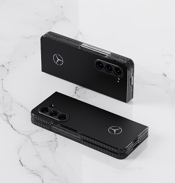 Two Galaxy Z Fold 5 Mercedes cases are mounted on a marble background and shown folded. The upper Galaxy Z Fold 5 is standing upright, and the lower Galaxy Z Fold 5 is shown lying down toward the camera.