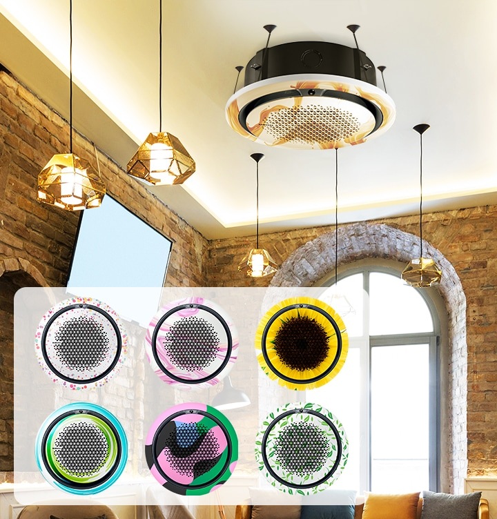 브라운톤의 벽돌로 인테리어 되어있는 카페같은 공간에 좌측 벽면에 상단은 벽돌로 되어있고 하단은 베이지톤으로 되어있으며 벽돌에 동그란 거울이 6개가 벽면 좌측에 붙어 있으며 가운데엔 티비가 설치되어 보입니다. 우측 정면엔 라운드 형의 창문이 보이며 창문엔 햇발이 가득 들어오고 있습니다. 라운드형 창문 주변에 벽돌로 인테리어 되어있으며 앞에 는 라운드 형의 쇼파와가 보여지고 쇼파위에는 베이지톤, 블루, 옐로우,그레이 쿠션이 보여집니다. 쇼파앞에는 쇼파와 같은톤의 일인용 의자와 동그란 탁자가 보여지며 천장에는 360시스템에어컨이 설치되어 보여집니다. 시스템에어컨에는 브라운계열의 디자인 판넬이 장착되어 있으며 브라운톤 계열의 인테리어와 조화를 이룹니다. 좌측 하단에 디자인 판넬 종류6가지가 보여집니다. 